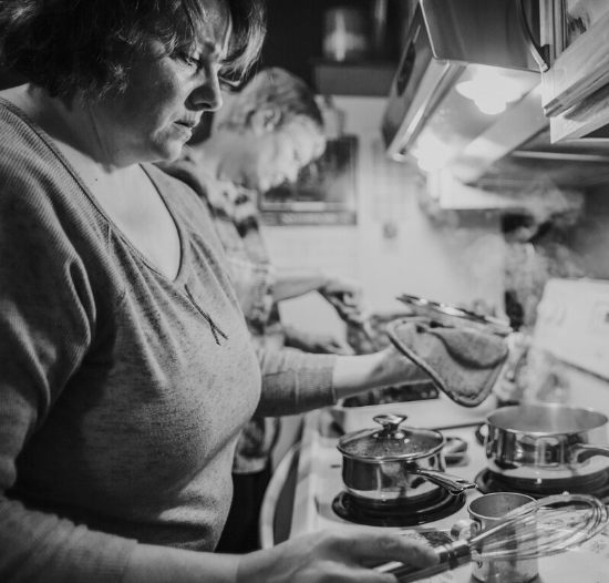 Woman cooking dinner for family