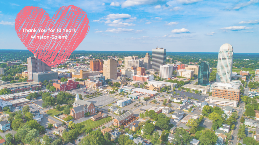 A picture of the Winston-Salem city skyline with a heart over it thanking the city for 10 years in business.