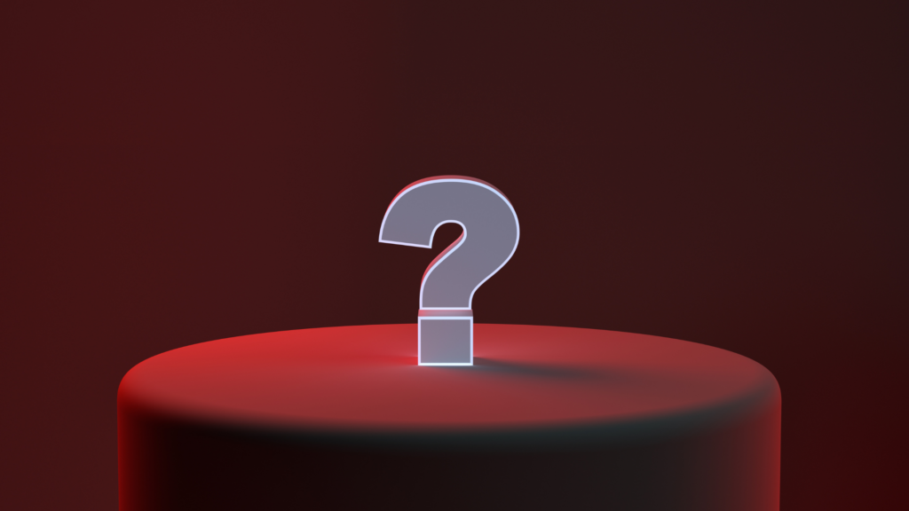 White question mark sitting on a red tablecloth in a red room.