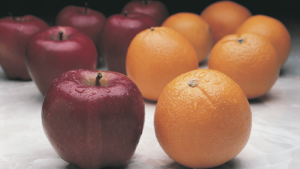 apples and oranges sitting on a table
