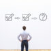 A business man staring at a white board with two checkmarks and a third step marked with a question mark. This is the header image accompanying a blog post titled - What Happens After a Trial Work Period for Social Security Disability in North Carolina?