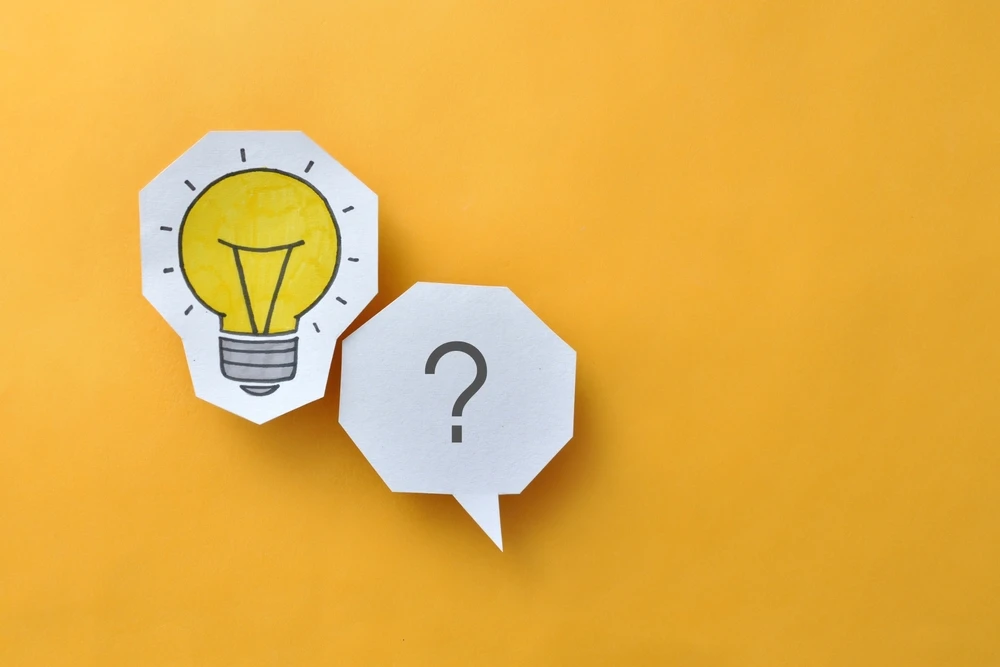A light bulb and question mark illustration on a yellow background which is the header image for a blog post titled - How Social Security Decides If You Can Still Work in North Carolina
