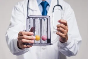 Male doctor in a white lab coat and stethoscope holding a test tube. This is the featured image for a blog post titled - "What Is Residual Functional Capacity in a North Carolina Disability Claim?"