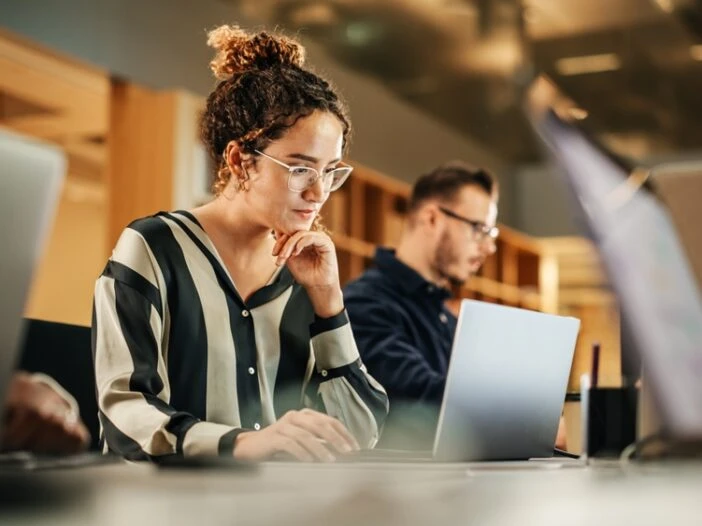 Header image showing a woman working at a computer accompanying a blog post titled - "What Is Substantial Gainful Activity in a North Carolina Disability Claim?"