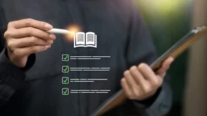 Header image of a hand and stylus pointing to a stylized list that accompanies a blog post titled - "What Does It Mean to Meet or Equal a Listing in a North Carolina Disability Claim?"