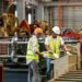 Image of two men in safety vests working in a factory which is the header image for a blog post titled: "What Is an Unsuccessful Work Attempt in a North Carolina Disability Claim?"